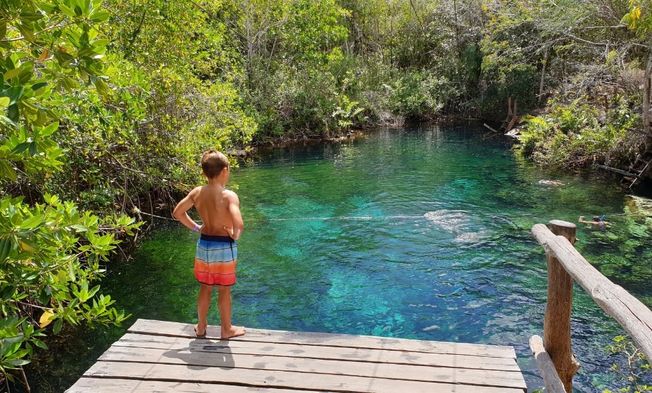 A kid in cavation in front of a river
